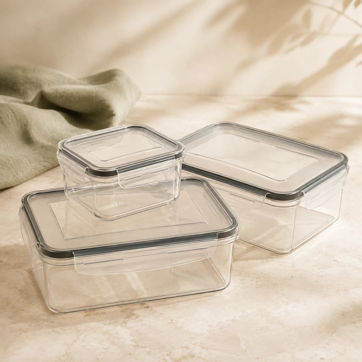A selection of three empty clear containers with matching grey-seal clip lids